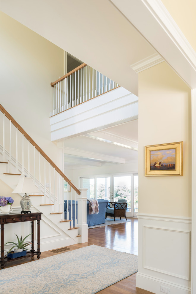 This is an example of a beach style foyer in Boston with medium hardwood floors.