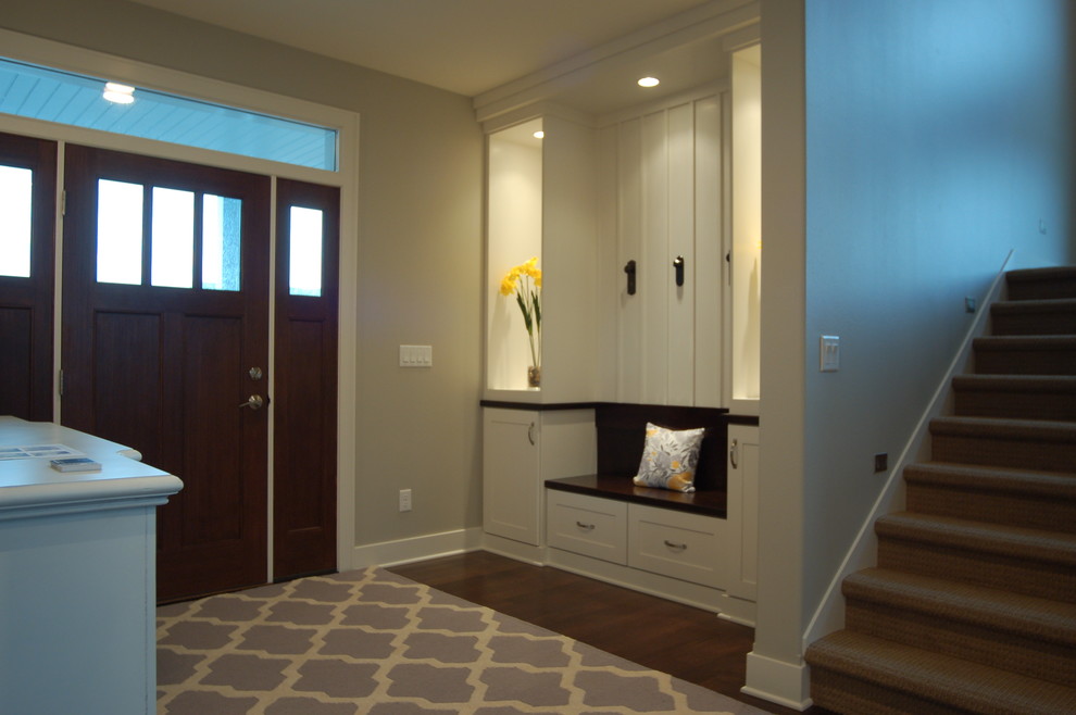 Example of a mid-sized transitional dark wood floor foyer design with gray walls and a dark wood front door