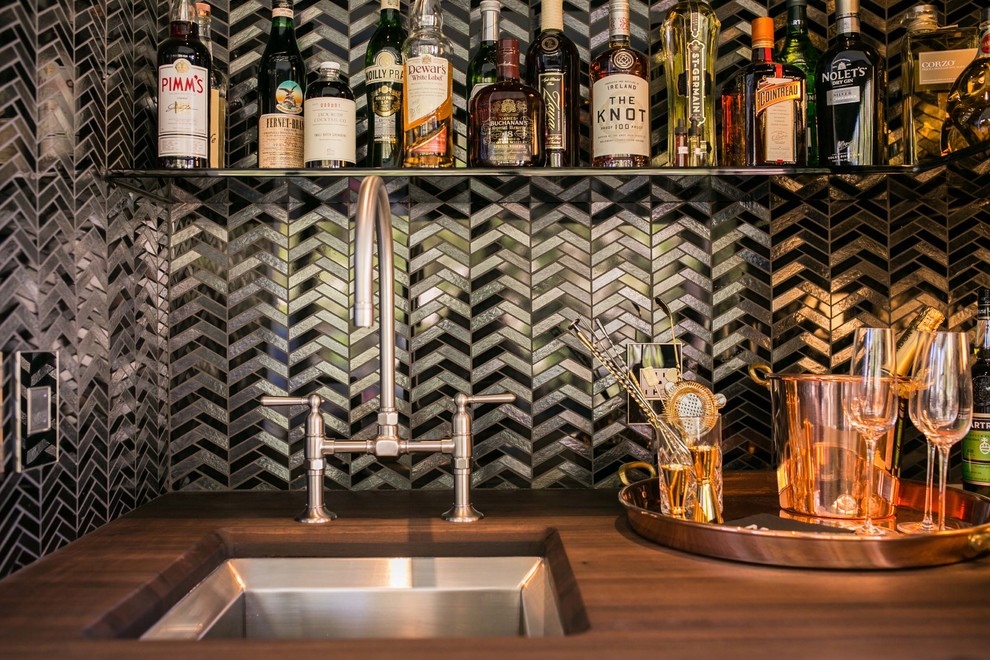 Inspiration for a mid-sized modern single-wall wet bar in San Francisco with an undermount sink, raised-panel cabinets, black cabinets, wood benchtops, multi-coloured splashback and metal splashback.