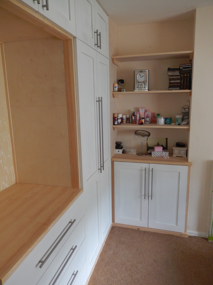Small traditional gender-neutral built-in wardrobe in Devon with shaker cabinets, white cabinets and carpet.