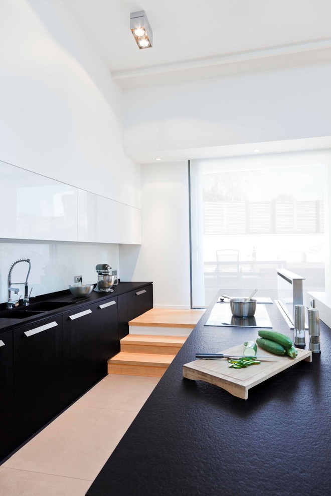 Inspiration for a large contemporary galley open plan kitchen in Lyon with black cabinets and with island.