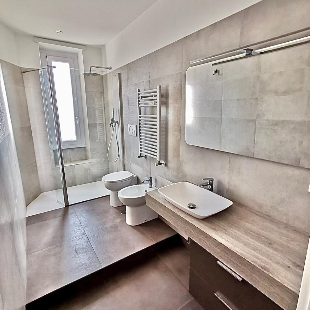 Bathroom - mid-sized contemporary beige tile and porcelain tile porcelain tile, brown floor, single-sink and tray ceiling bathroom idea in Rome with brown cabinets, a two-piece toilet, a vessel sink, wood countertops and a floating vanity