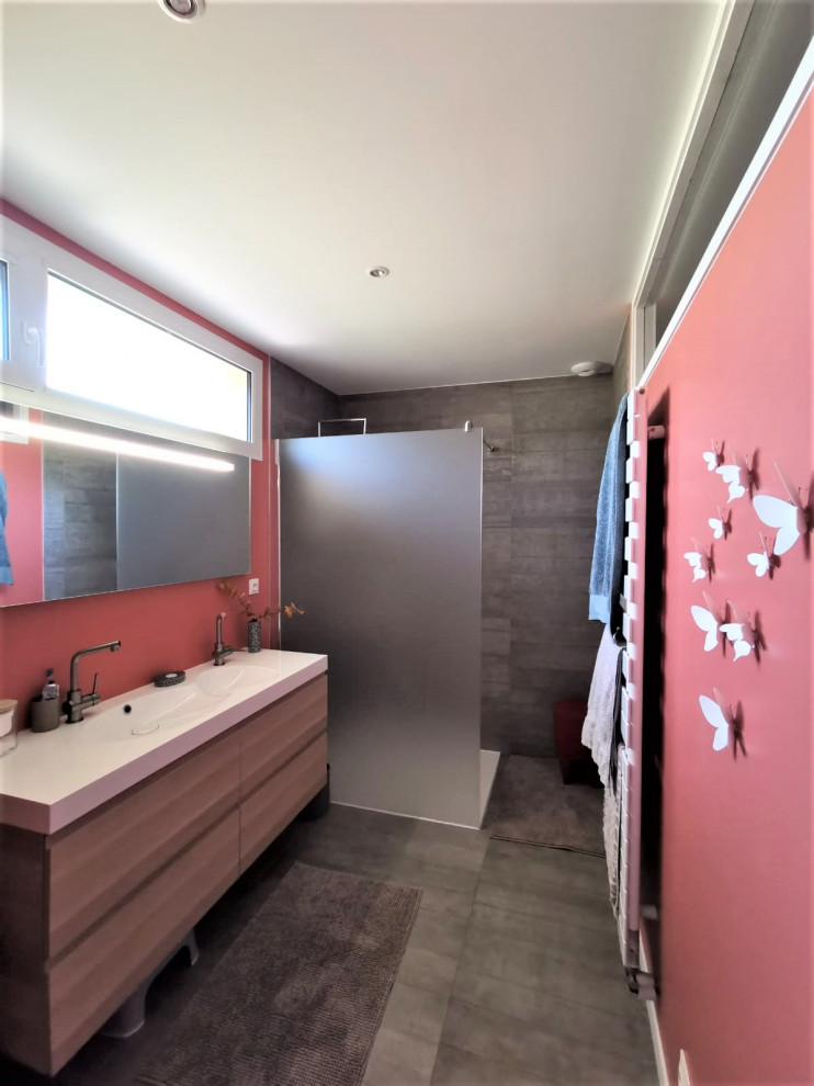Photo of a small modern 3/4 bathroom in Toulouse with beaded inset cabinets, light wood cabinets, a curbless shower, a two-piece toilet, gray tile, ceramic tile, orange walls, ceramic floors, a console sink, tile benchtops, grey floor, grey benchtops, a double vanity and a floating vanity.