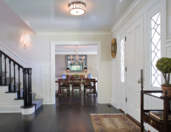 Design ideas for a large arts and crafts foyer in New York with white walls, dark hardwood floors, a single front door and a white front door.