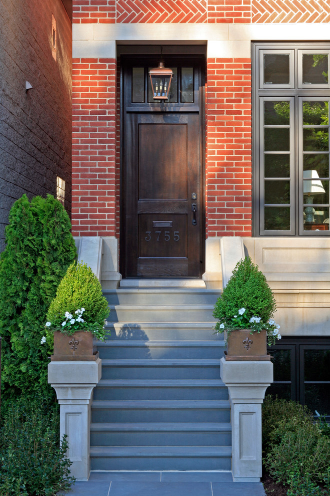 Design ideas for a large traditional three-storey brick red exterior in Chicago.
