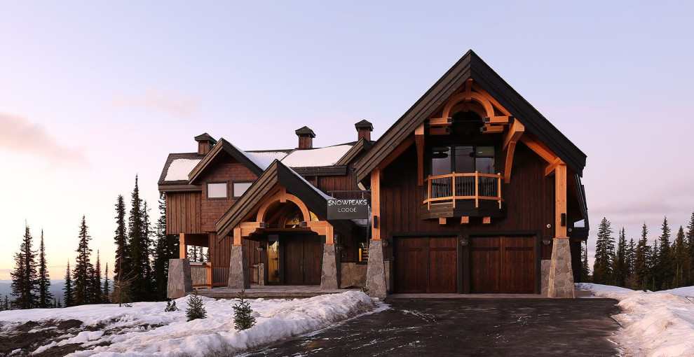 Inspiration for a large country three-storey brown house exterior in Vancouver with wood siding, a gable roof and a shingle roof.