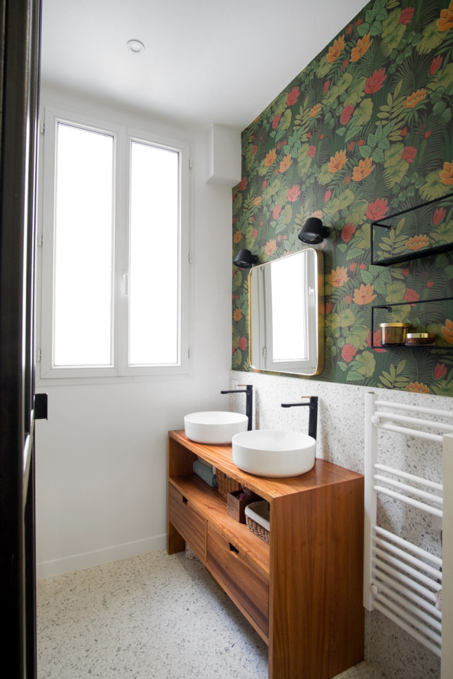 This is an example of a contemporary bathroom in Paris with flat-panel cabinets, medium wood cabinets, white tile, stone slab, multi-coloured walls, a vessel sink, wood benchtops, white floor, brown benchtops, a double vanity, a freestanding vanity and wallpaper.