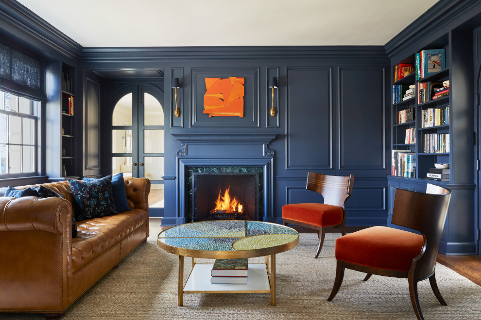 Design ideas for a mid-sized transitional study room in New York with blue walls, dark hardwood floors, a standard fireplace and brown floor.