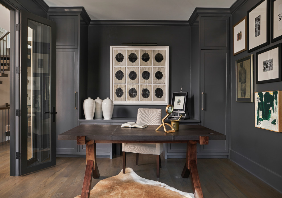 Photo of a mid-sized transitional study room in Chicago with black walls, dark hardwood floors, no fireplace, a freestanding desk and brown floor.