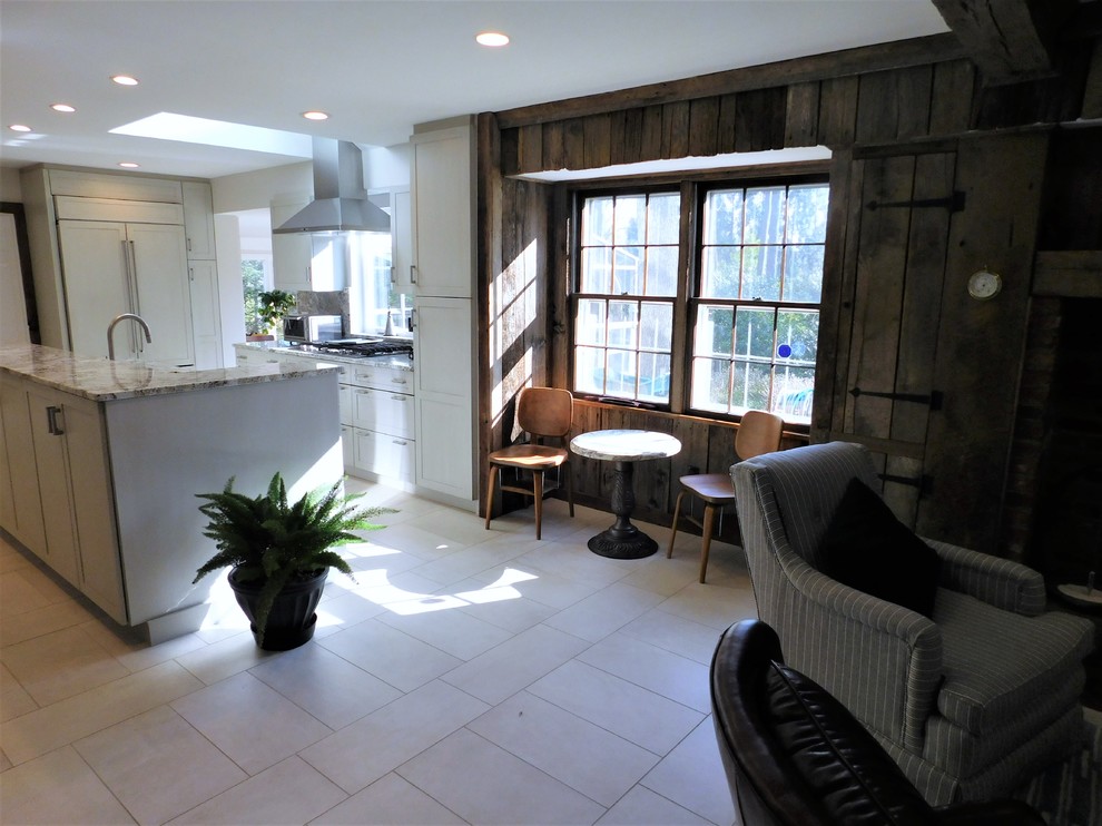 Inspiration for a mid-sized transitional u-shaped ceramic tile and white floor open concept kitchen remodel in DC Metro with an undermount sink, recessed-panel cabinets, white cabinets, marble countertops, stainless steel appliances and an island