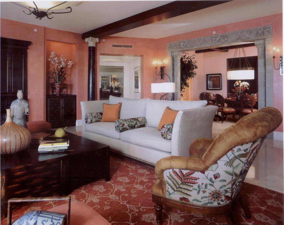 This is an example of a large contemporary living room in Tampa with pink walls, marble floors and no fireplace.