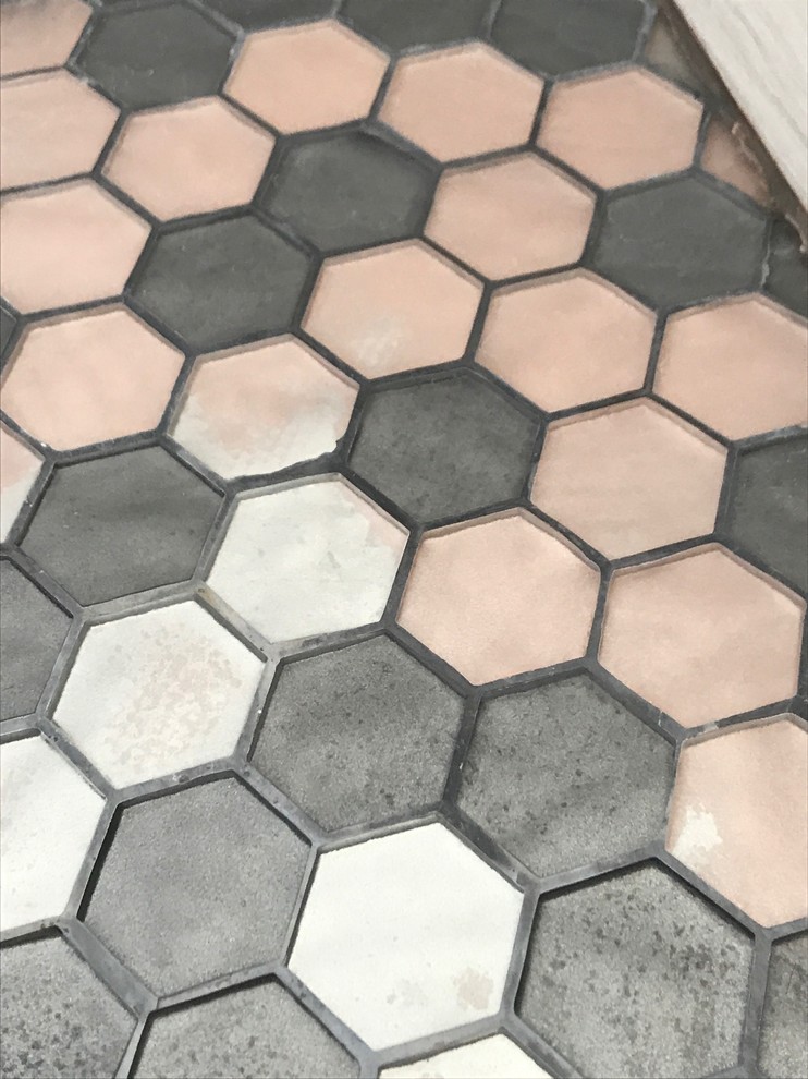 Is water supposed to leak under shower floor tiles?? Pictures included