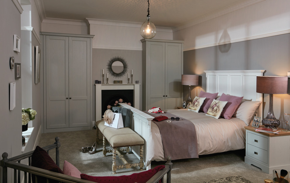 Design ideas for a mid-sized contemporary master bedroom in Cambridgeshire with grey walls, painted wood floors, no fireplace and a stone fireplace surround.