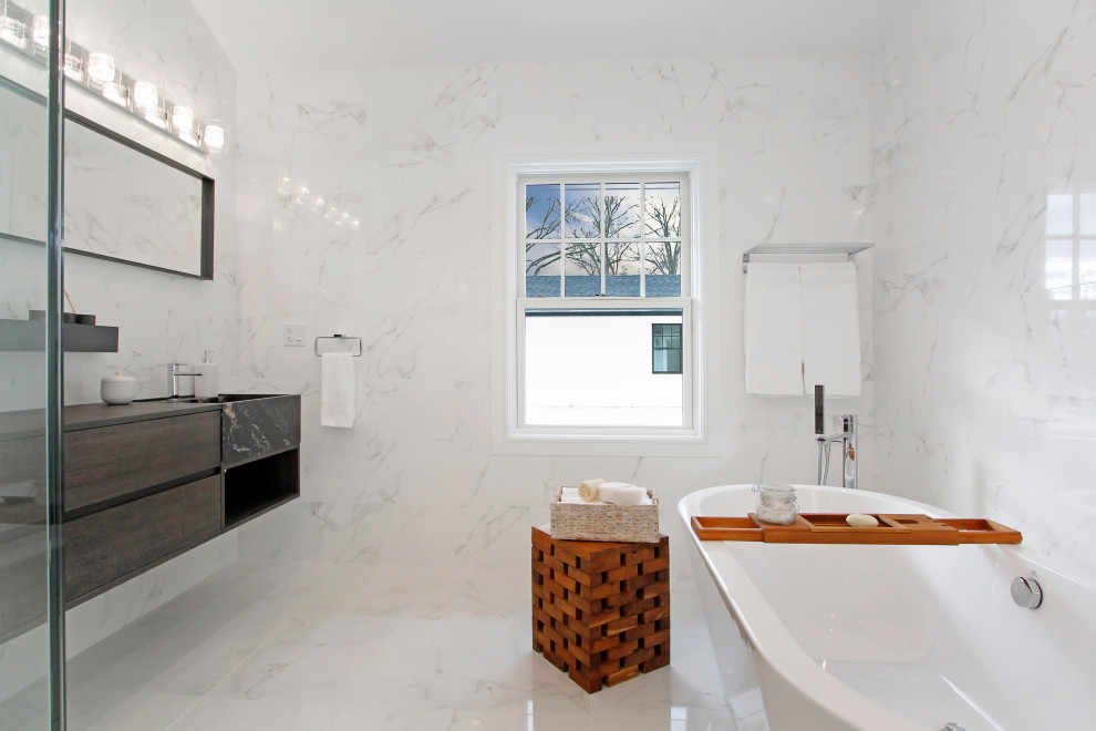 Large trendy master white tile and marble tile marble floor, white floor and double-sink bathroom photo in New York with flat-panel cabinets, medium tone wood cabinets, a one-piece toilet, white walls, a drop-in sink, wood countertops, a hinged shower door, brown countertops and a floating vanity