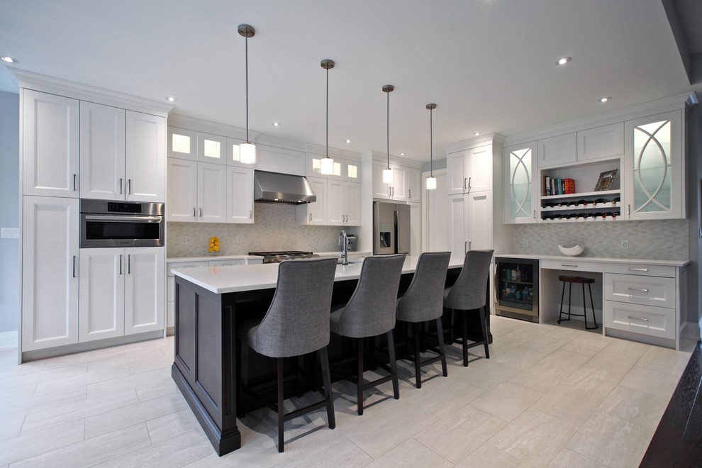 Inspiration for a large transitional l-shaped open plan kitchen in Toronto with an undermount sink, shaker cabinets, white cabinets, solid surface benchtops, multi-coloured splashback, mosaic tile splashback, stainless steel appliances, porcelain floors, with island and beige floor.