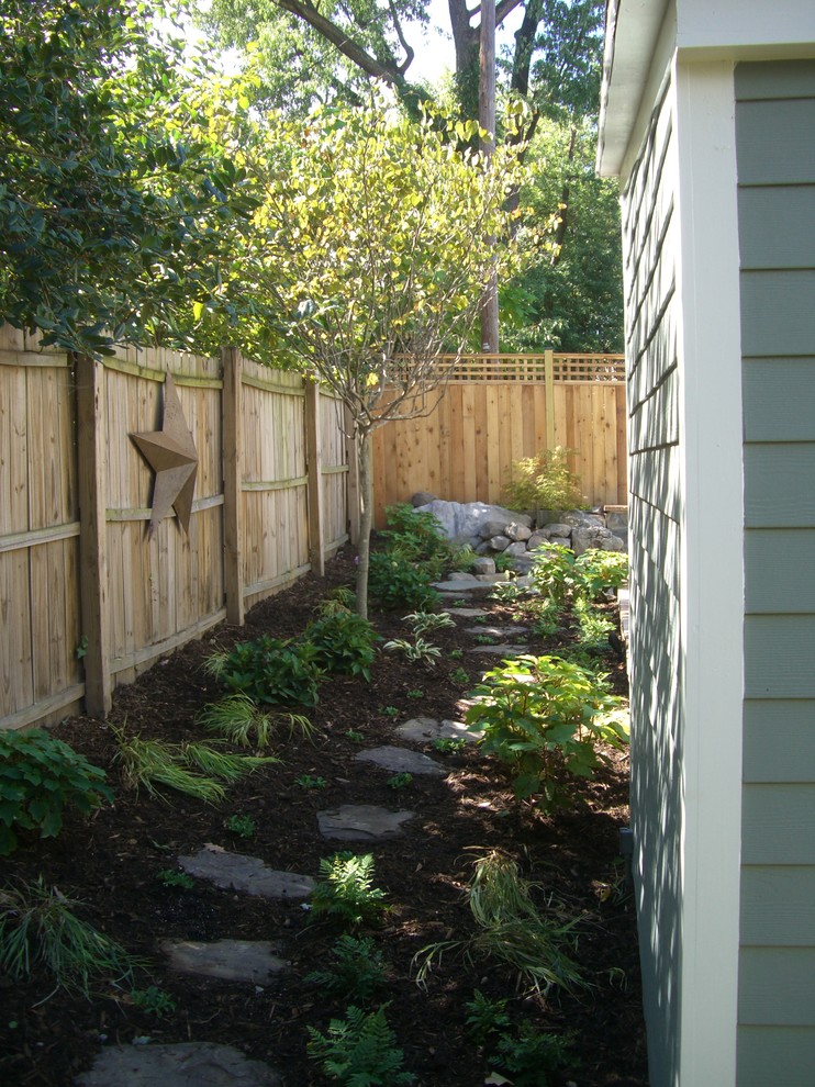 Inspiration for a large arts and crafts backyard partial sun garden for summer in DC Metro with a water feature and mulch.