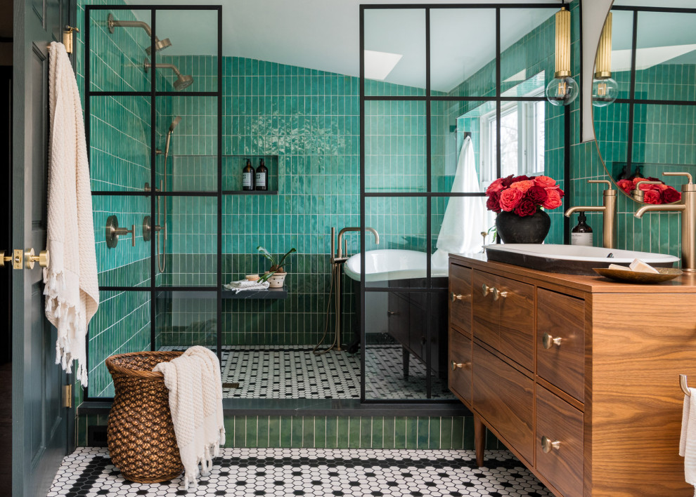 Photo of a mid-sized eclectic master bathroom in Chicago with flat-panel cabinets, medium wood cabinets, a claw-foot tub, a shower/bathtub combo, green tile, porcelain tile, white walls, porcelain floors, a drop-in sink, wood benchtops, black floor, an open shower, brown benchtops, a niche, a double vanity and a freestanding vanity.