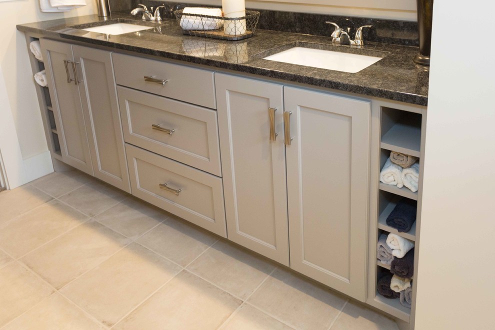 This is an example of a mid-sized arts and crafts bathroom in San Diego with recessed-panel cabinets, grey cabinets, porcelain floors, an undermount sink, granite benchtops and beige floor.