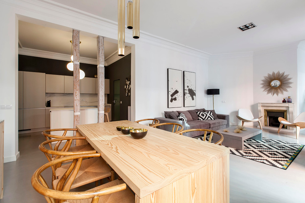 Photo of a large eclectic open plan dining in Madrid with white walls and a standard fireplace.