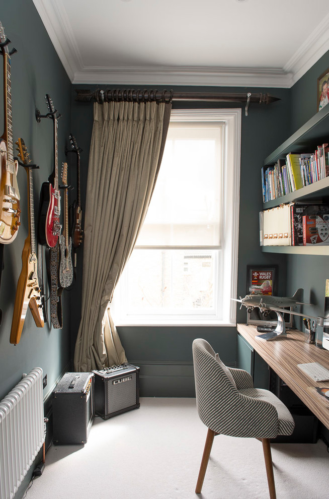 Inspiration for an eclectic home office in London with green walls, carpet, a built-in desk and grey floor.