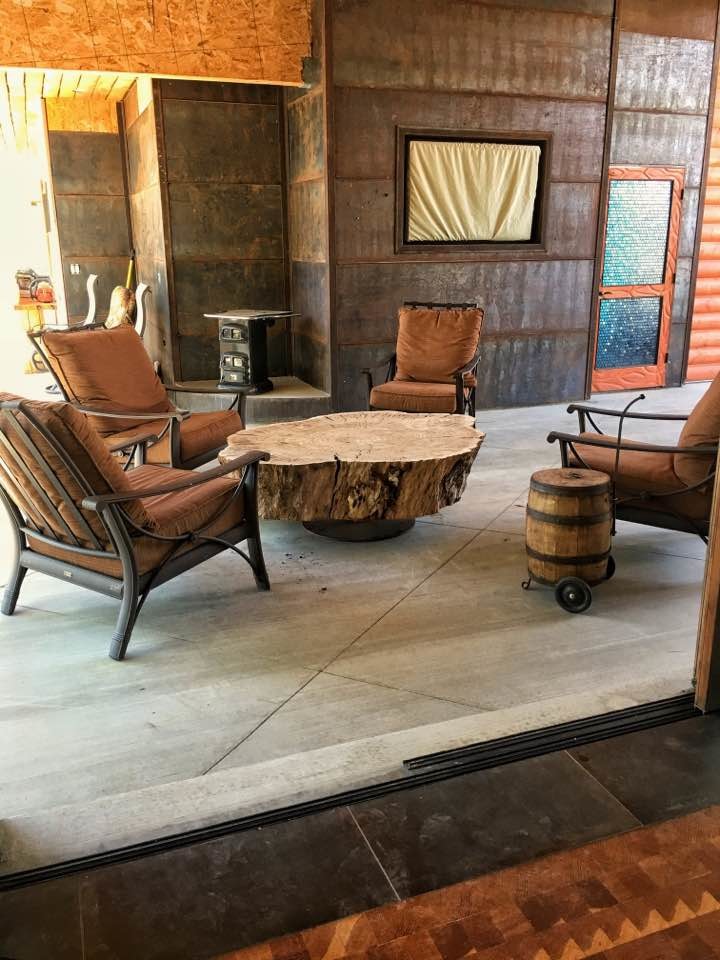 Mid-sized mountain style backyard concrete paver patio photo in Phoenix with a roof extension