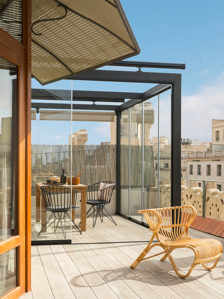 Design ideas for a large mediterranean rooftop and rooftop deck in Barcelona with a pergola.