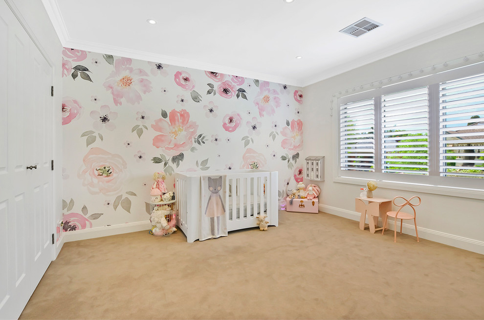 This is an example of a large traditional nursery for girls in Sydney with beige walls, carpet and beige floor.