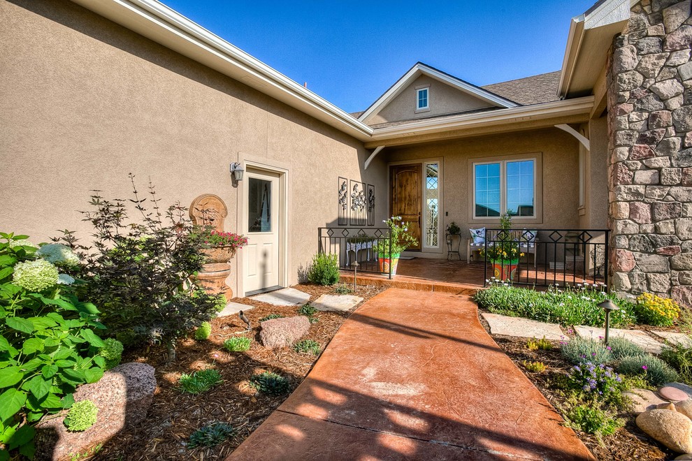 Photo of a mid-sized transitional partial sun front yard stone walkway in Denver.