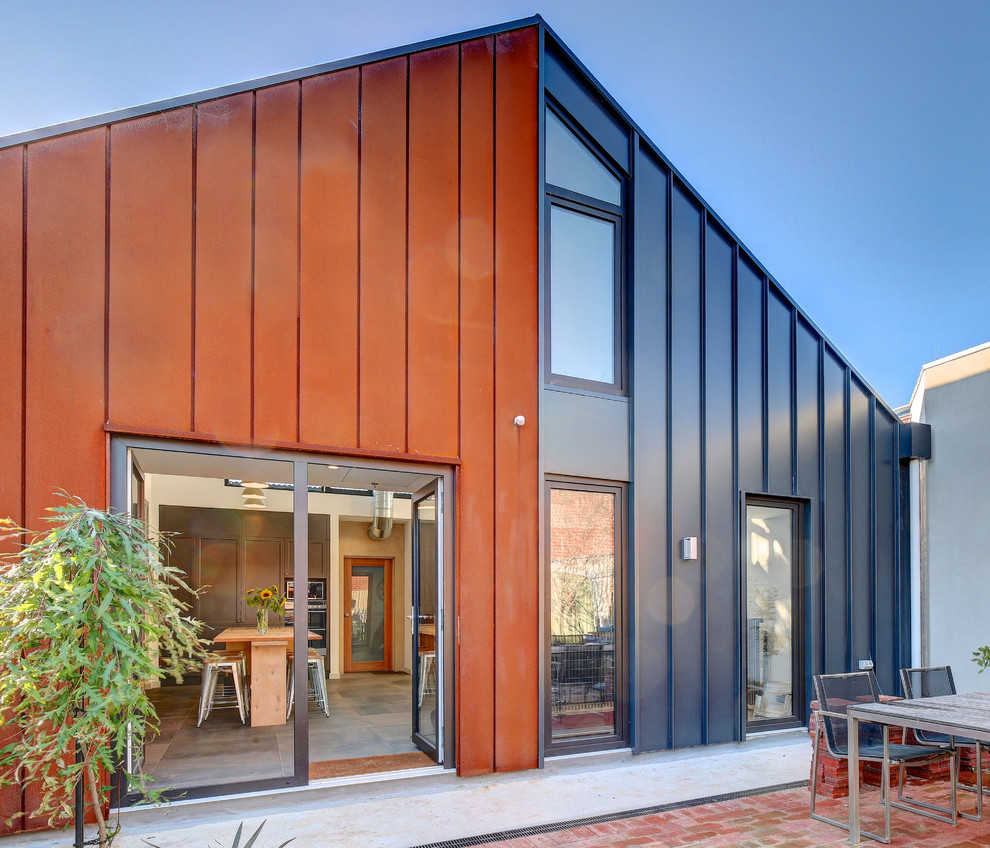 This is an example of a small contemporary one-storey grey house exterior in Adelaide with metal siding, a gable roof and a metal roof.