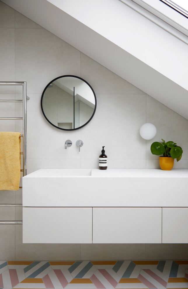 Inspiration for a small contemporary kids bathroom in London with white cabinets, a corner shower, an urinal, beige tile, ceramic tile, beige walls, cement tiles, a wall-mount sink, multi-coloured floor, a single vanity and a floating vanity.