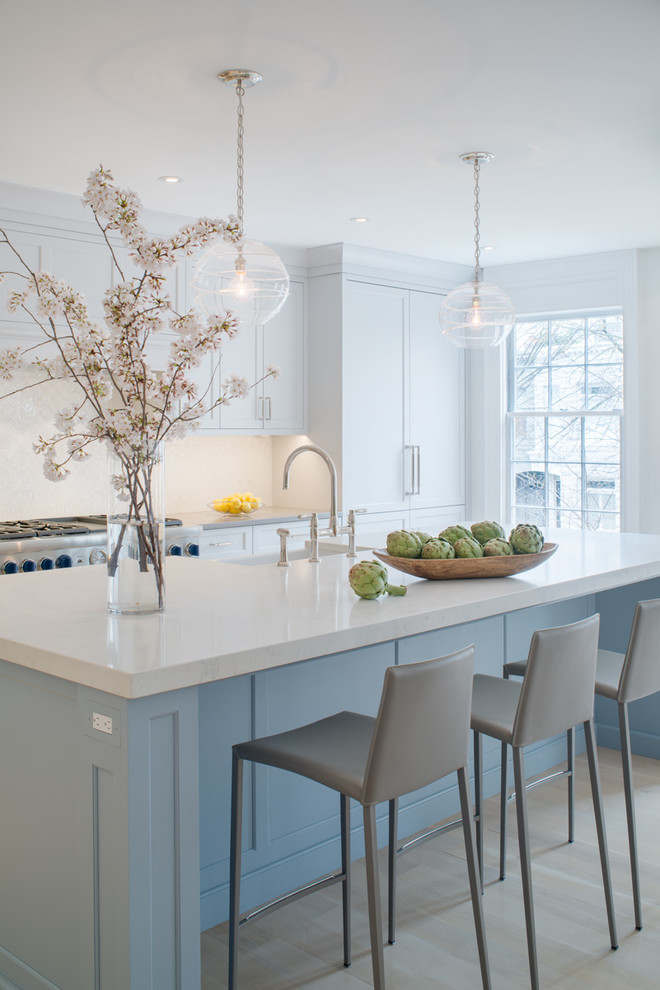 Large transitional single-wall laminate floor and beige floor eat-in kitchen photo in DC Metro with a farmhouse sink, flat-panel cabinets, blue cabinets, quartz countertops, white backsplash, mosaic tile backsplash, stainless steel appliances, an island and gray countertops