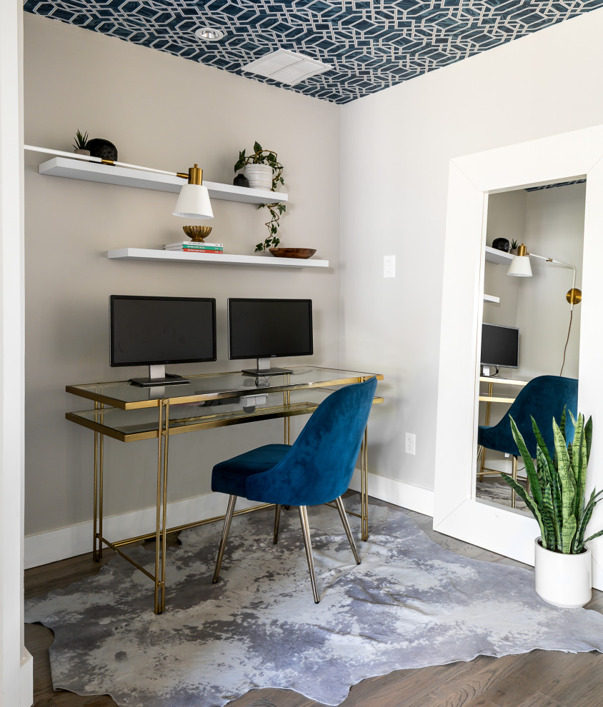 Design ideas for a mid-sized midcentury home office in Dallas with grey walls, medium hardwood floors, no fireplace, a freestanding desk and wallpaper.