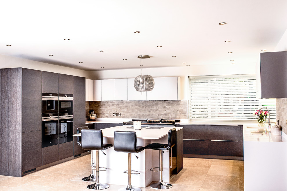 Design ideas for a medium sized contemporary l-shaped open plan kitchen with a single-bowl sink, flat-panel cabinets, medium wood cabinets, quartz worktops, beige splashback, stone tiled splashback, black appliances, porcelain flooring, an island, beige floors and white worktops.
