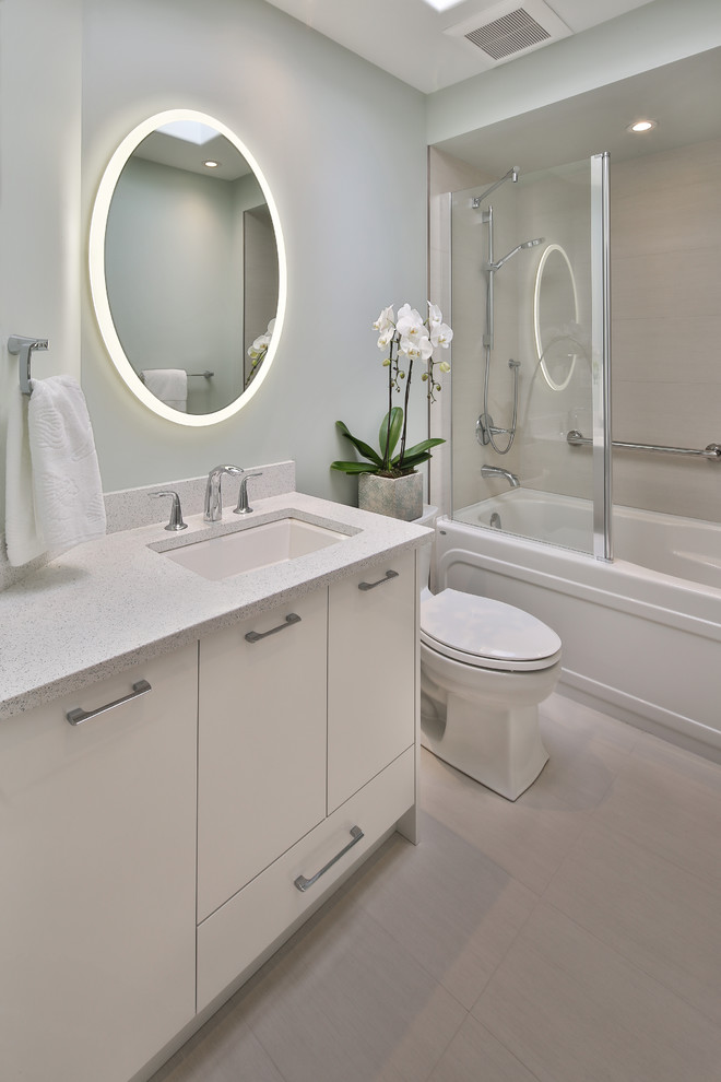Photo of a small contemporary 3/4 bathroom in Other with white cabinets, an alcove tub, a shower/bathtub combo, a sliding shower screen, white benchtops, flat-panel cabinets, beige tile, porcelain tile, porcelain floors, an undermount sink, beige floor and grey walls.