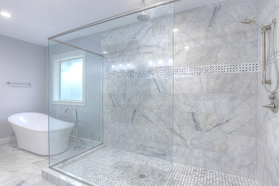 Design ideas for a mid-sized contemporary master bathroom in Tampa with recessed-panel cabinets, medium wood cabinets, a corner shower, beige tile, marble, blue walls, marble floors, an undermount sink, engineered quartz benchtops, white floor, a hinged shower door and a freestanding tub.