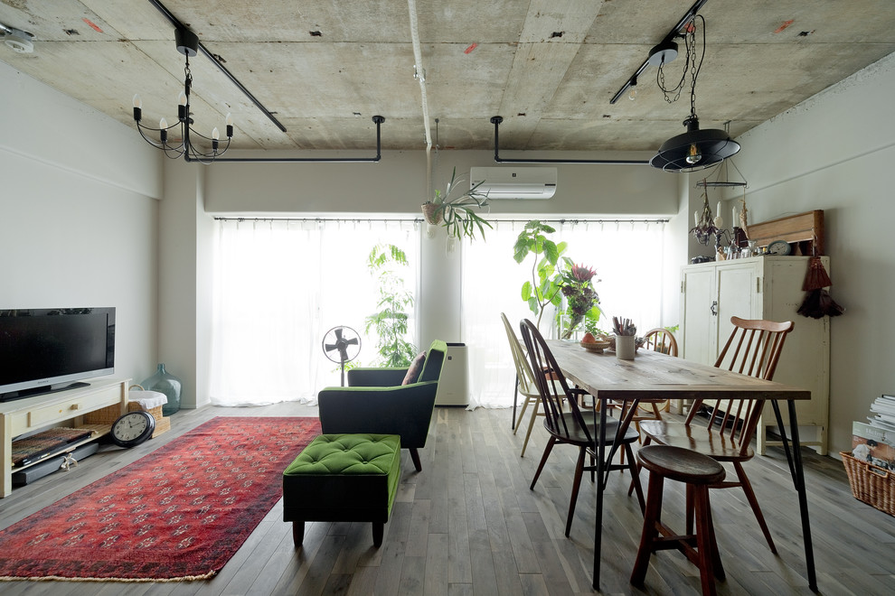 Inspiration for a small industrial open concept living room in Osaka with white walls, light hardwood floors and grey floor.