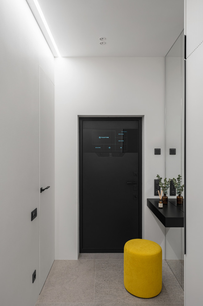 Cette photo montre une porte d'entrée tendance de taille moyenne avec un mur blanc, un sol en carrelage de porcelaine, une porte simple, une porte noire et un sol beige.
