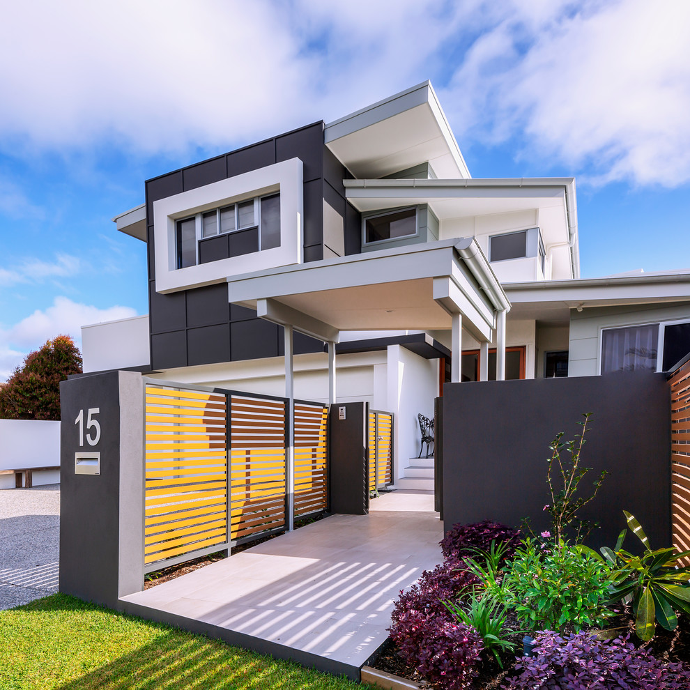 Design ideas for a large contemporary three-storey multi-coloured house exterior in Sunshine Coast with a metal roof, mixed siding and a shed roof.