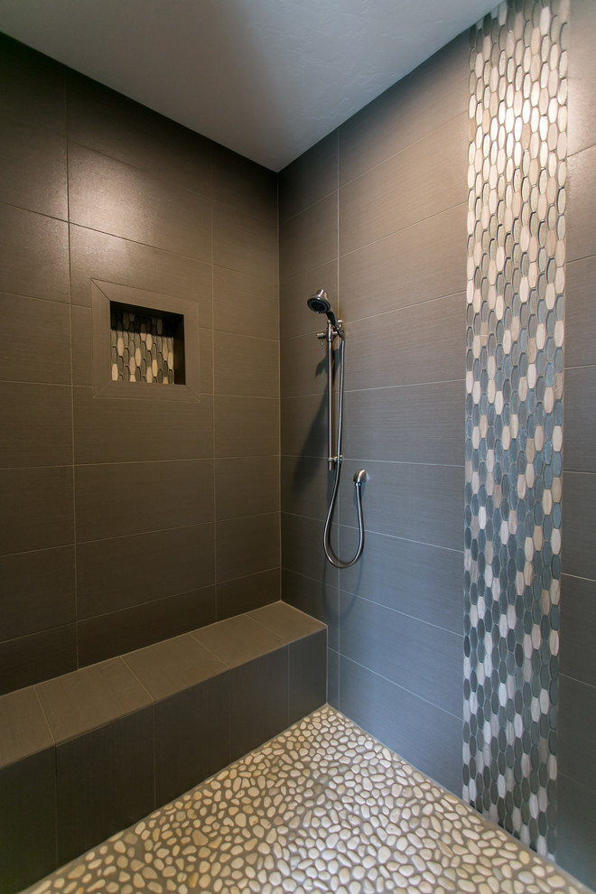 Photo of a large transitional master bathroom in Seattle with shaker cabinets, dark wood cabinets, a corner tub, an open shower, a two-piece toilet, brown tile, porcelain tile, grey walls, porcelain floors, an undermount sink, engineered quartz benchtops, grey floor and an open shower.