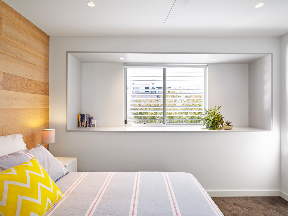 Inspiration for a mid-sized contemporary bedroom in Sydney with white walls and carpet.