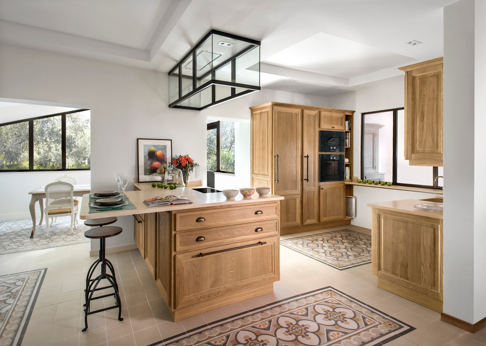 Inspiration for a large transitional galley eat-in kitchen in Nice with recessed-panel cabinets, light wood cabinets and a peninsula.