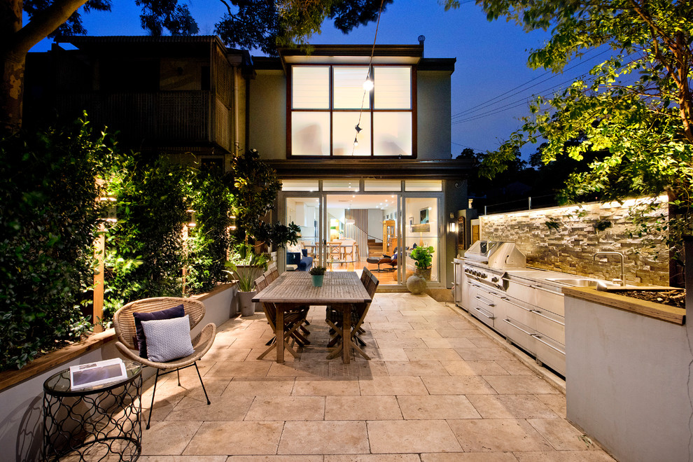 This is an example of a midcentury backyard garden in Sydney with brick pavers.