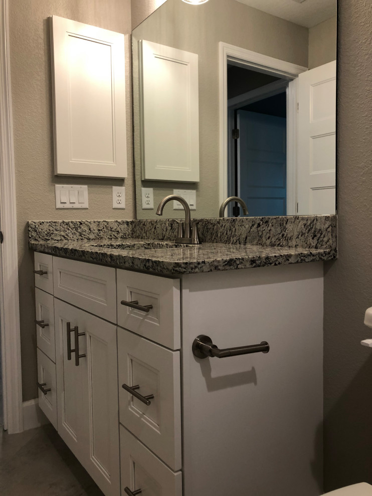 Small traditional master bathroom in Other with white cabinets, a corner tub, a shower/bathtub combo, a one-piece toilet, beige walls, ceramic floors, an undermount sink, beige floor, an open shower, grey benchtops, a single vanity, a freestanding vanity, shaker cabinets and granite benchtops.