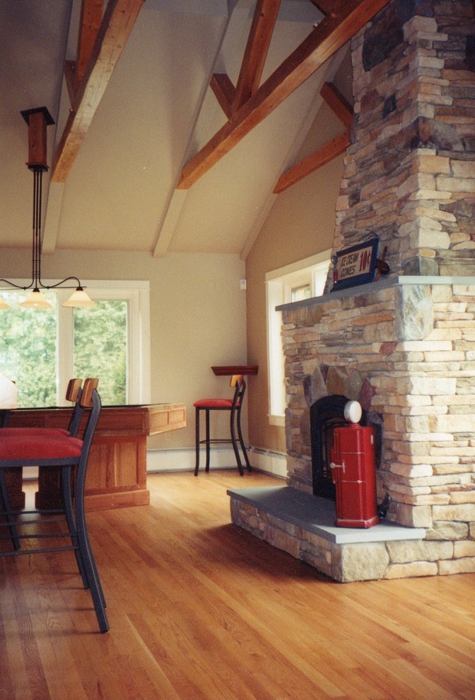 Example of a mid-sized mountain style formal and open concept light wood floor living room design with beige walls, a standard fireplace, a stone fireplace and no tv
