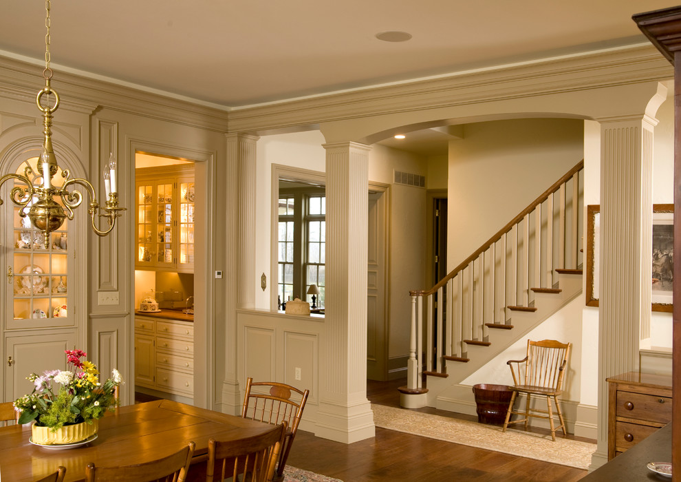 This is an example of a traditional dining room in Philadelphia with beige walls and dark hardwood floors.
