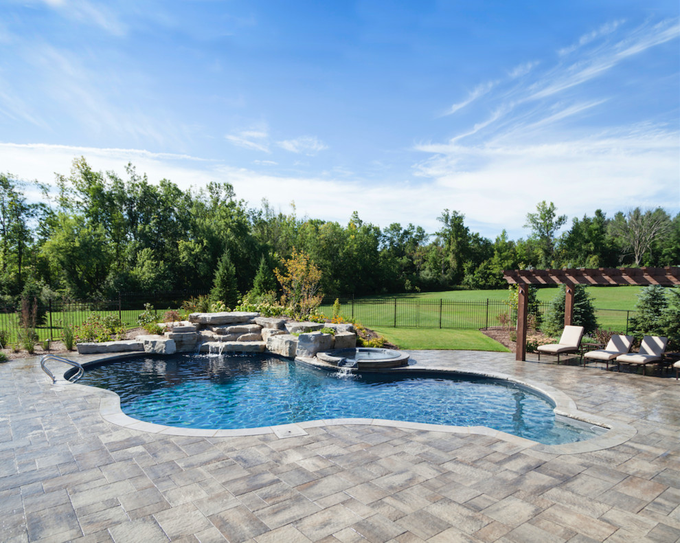 Pool - small transitional concrete paver and rectangular infinity pool idea in Toronto