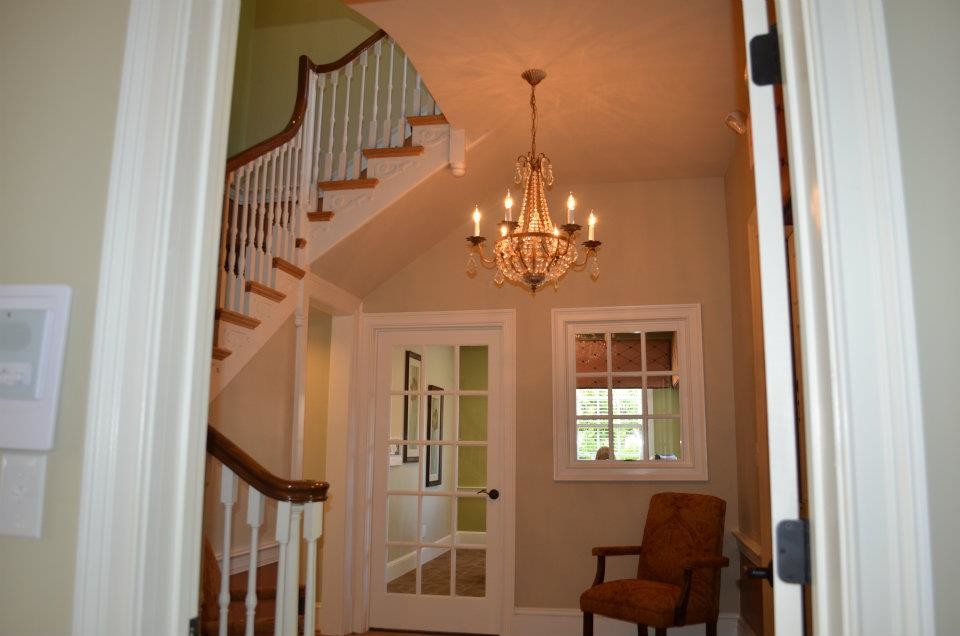 This is an example of a mid-sized traditional front door in Atlanta with yellow walls, medium hardwood floors, a single front door and a white front door.