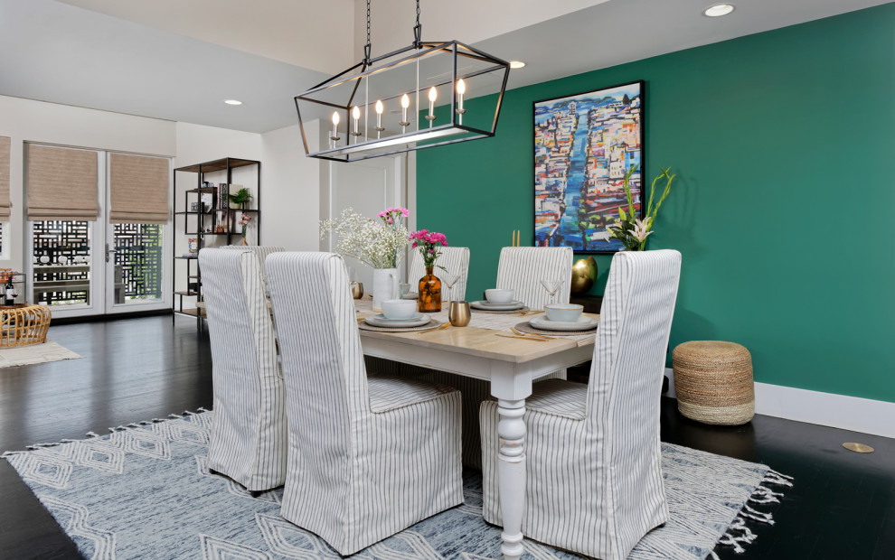 Photo of a mid-sized contemporary open plan dining in Denver with multi-coloured walls, no fireplace and black floor.