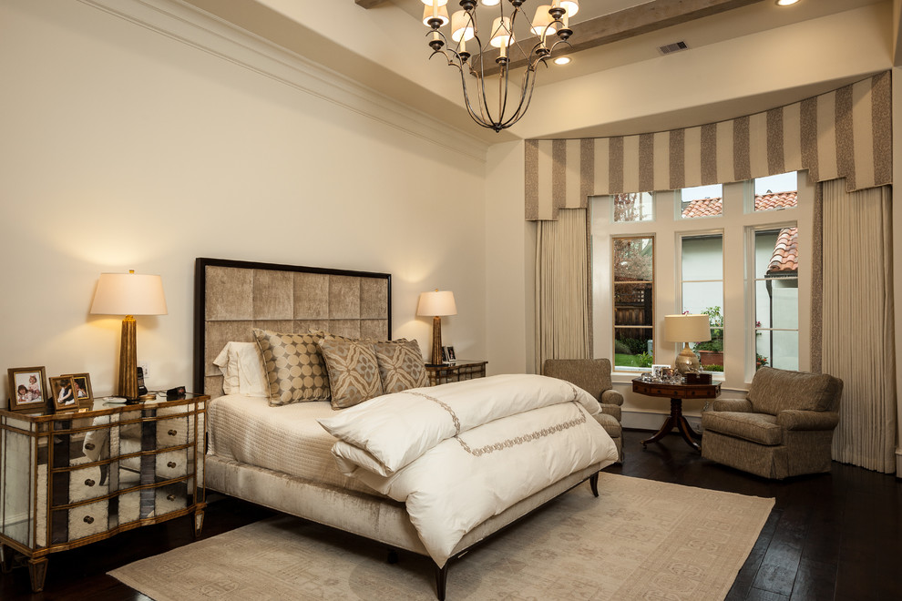 Large traditional master bedroom in Houston with beige walls, dark hardwood floors and no fireplace.