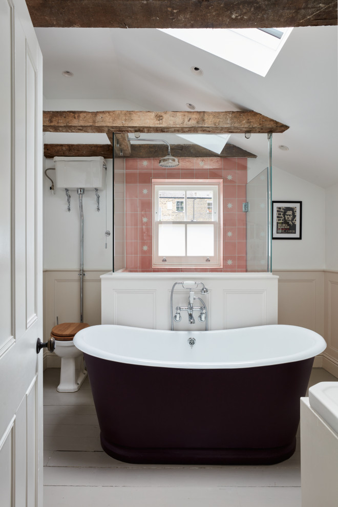 Inspiration for a small eclectic family bathroom in London with recessed-panel cabinets, beige cabinets, a freestanding bath, a walk-in shower, a wall mounted toilet, pink tiles, cement tiles, white walls, painted wood flooring, a submerged sink, grey floors, a hinged door, white worktops, a wall niche, a single sink, a freestanding vanity unit, exposed beams and panelled walls.